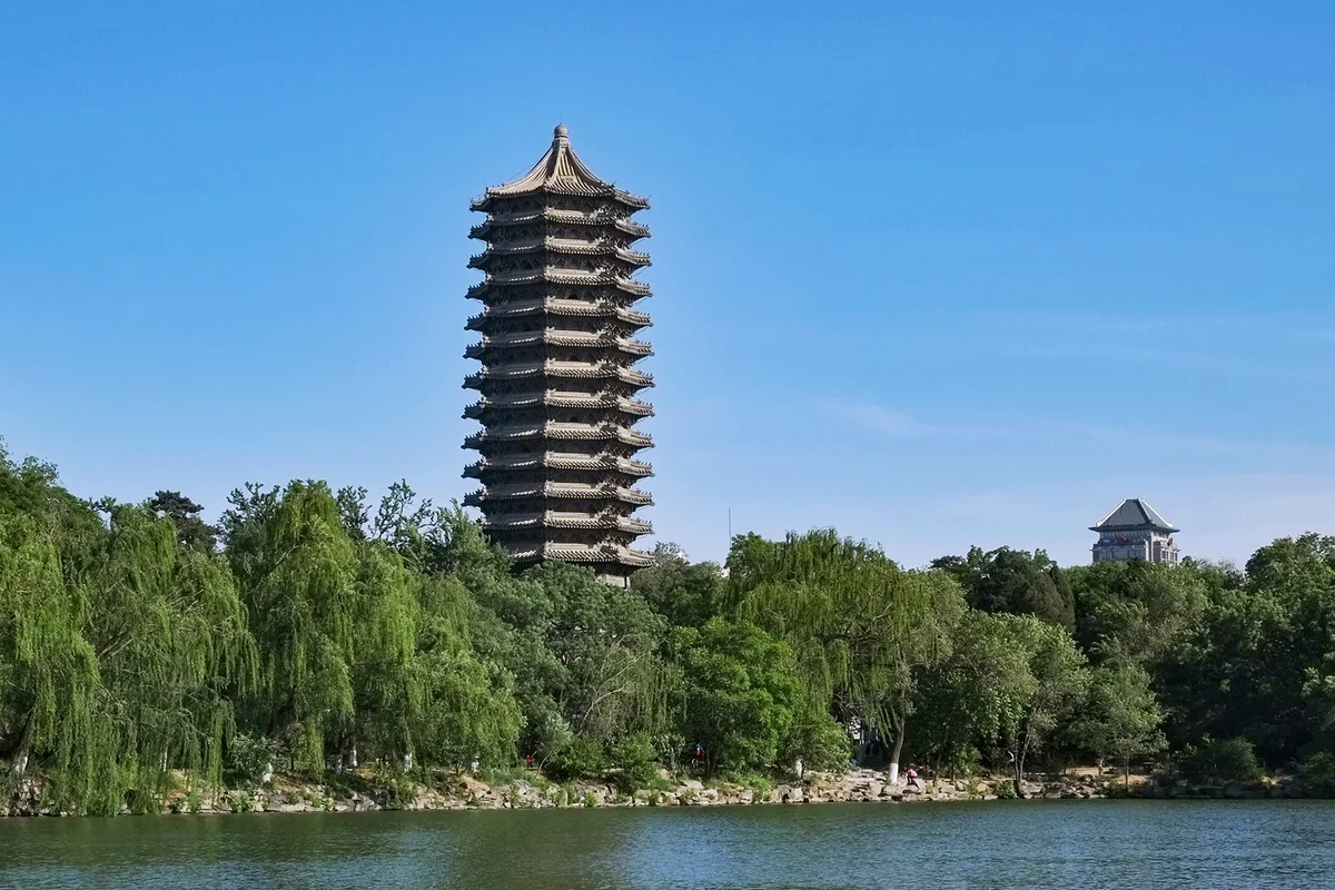 The thirteen-storey Boya Pagoda rising above willow trees on the shore of Weiming Lake