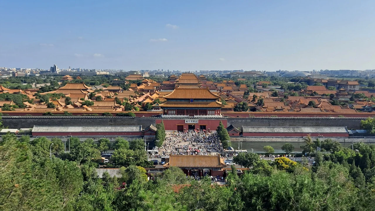 The golden roofs of the Forbidden City seen from Jingshan, with the Gate of Divine Prowess and a crowd at the north exit in front