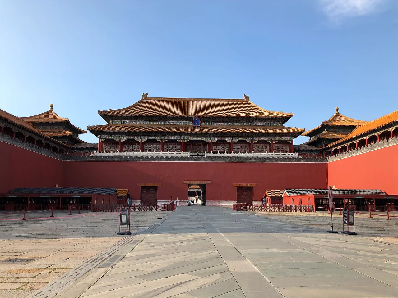 The red walls and double-roofed tower of the Meridian Gate, the south entrance of the Forbidden City, with an almost empty square in front